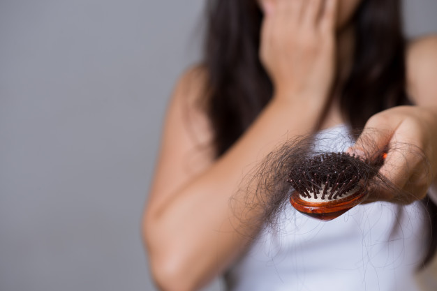 Brush full of hair from hair loss