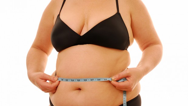 Menopausal woman measuring large waist